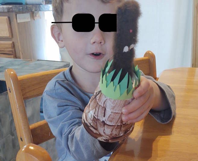 boy plays peek a boo with mole